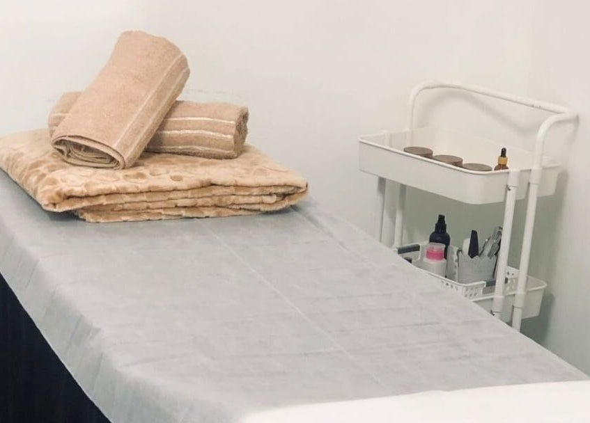 Massage bed with cozy linens at NK Beauty & Aesthetics, Upington, Northern Cape, ZA.