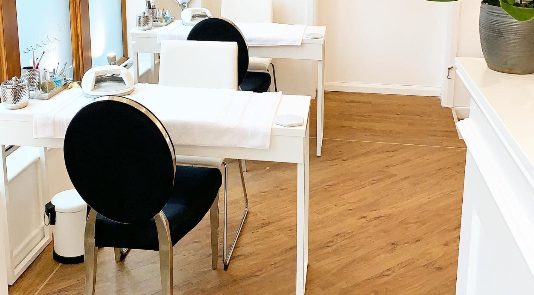 Chic nail studio at Enhance Beauty Salon, Halifax, England, GB showcasing elegant manicure stations.