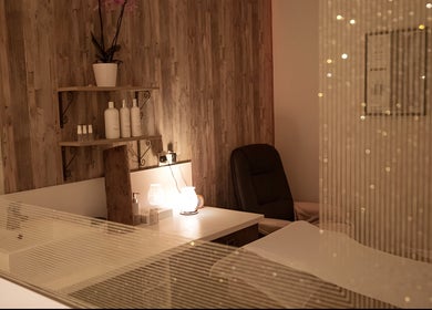 Relaxing spa room at Ruth's Retreat in Douglas, GB with soft lighting and wooden shelves.