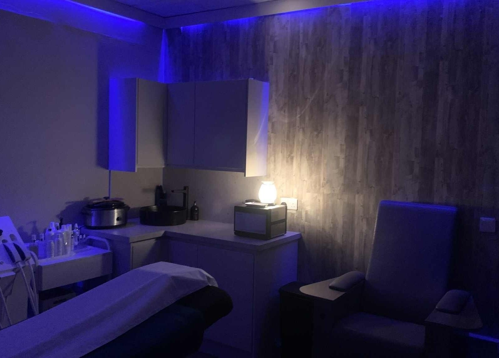 Relaxing treatment room at Ruth's Retreat, Douglas, GB, with soft lighting and soothing decor.