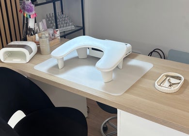 Nail workspace at Nails By Cait in Darwen, England, GB featuring manicure tools and a UV lamp.