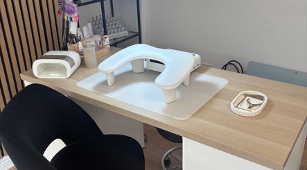 Nail workspace at Nails By Cait in Darwen, England, GB featuring manicure tools and a UV lamp.