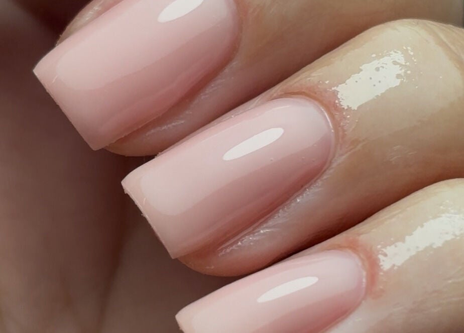 Close-up of glossy nude nails manicured at Nails By Cait, Darwen, England, GB, showcasing professional beauty care.
