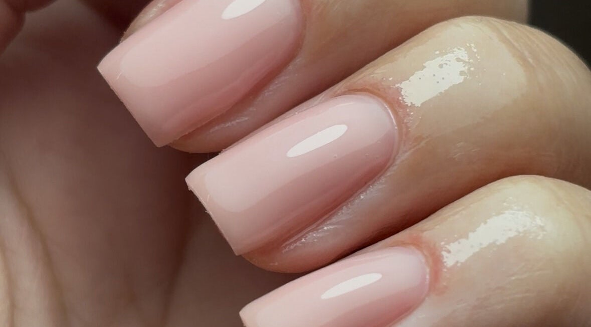 Close-up of glossy nude nails manicured at Nails By Cait, Darwen, England, GB, showcasing professional beauty care.