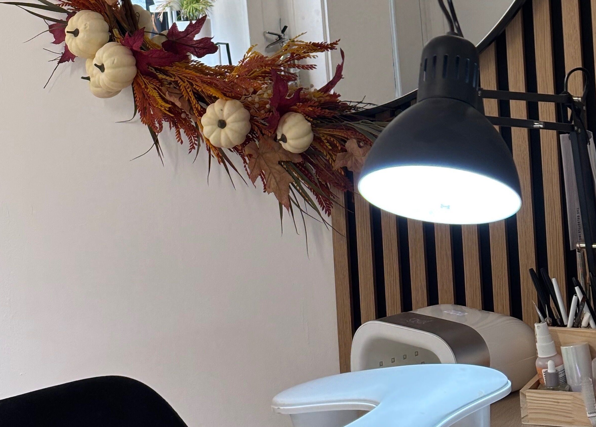 Nail station at Nails By Cait in Darwen, England, GB, featuring festive autumn decor and manicure tools.