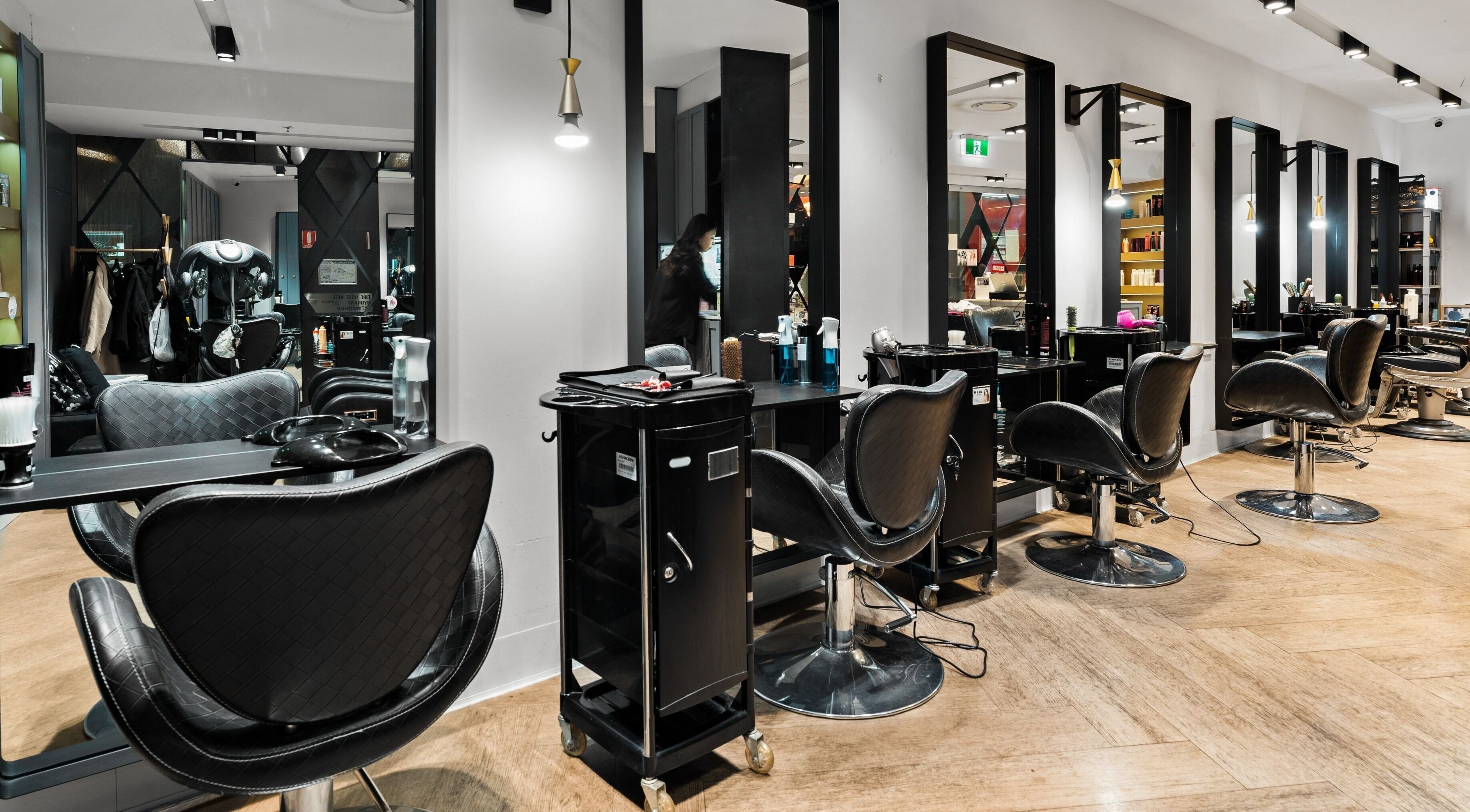 Modern salon interior at Hair at Greenwood, North Sydney, New South Wales, AU with stylish chairs and mirrors.