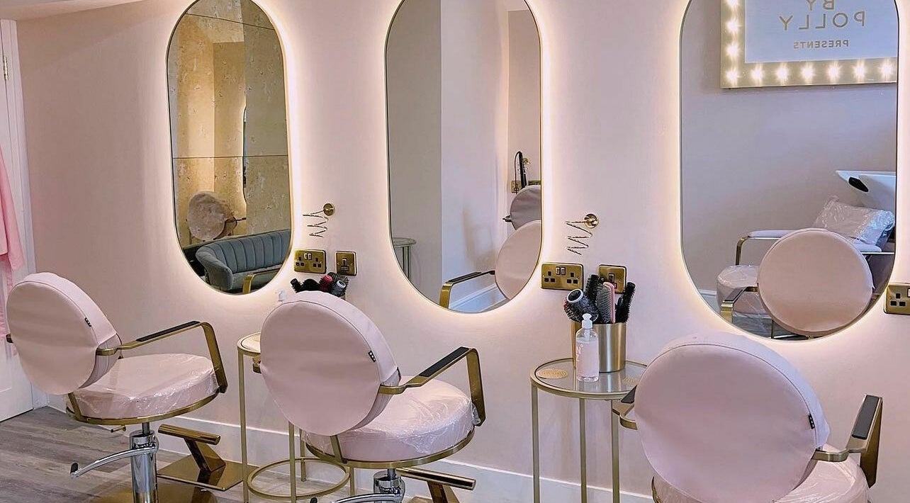 Elegant beauty station at Glam By Polly, Hemel Hempstead, England, GB with illuminated mirrors and stylish chairs.