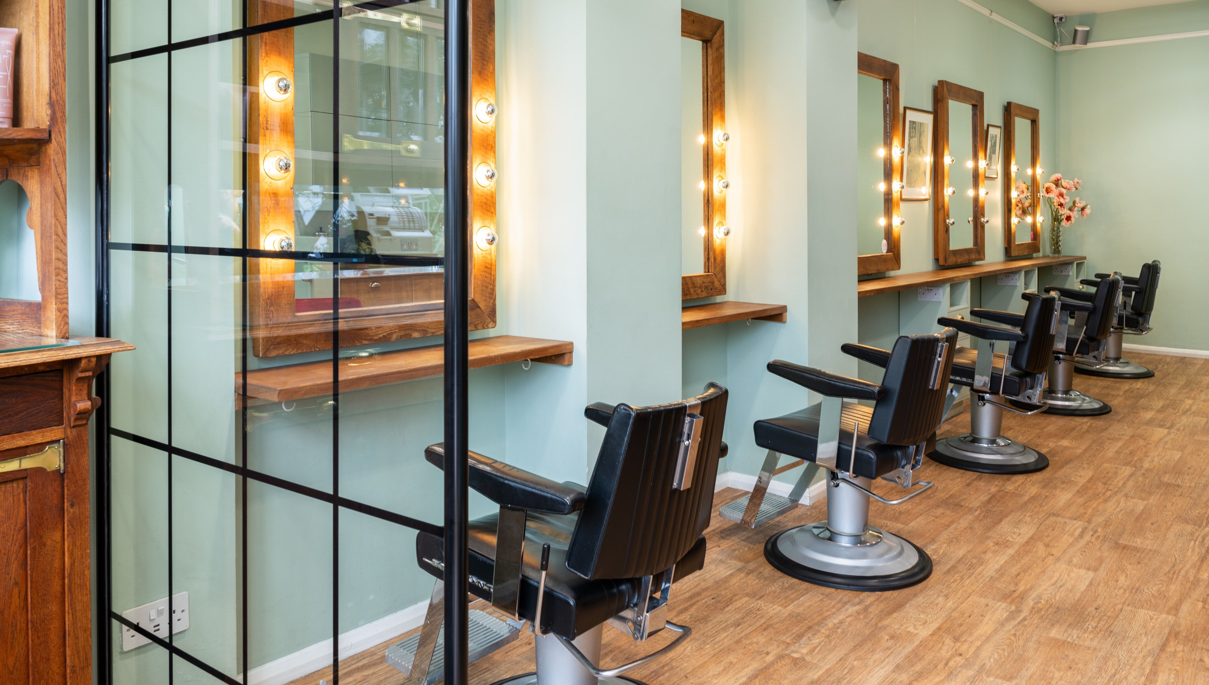 Elegant barber chairs and mirrors at Lisa Hauck, London, England, GB. Modern salon interior design.