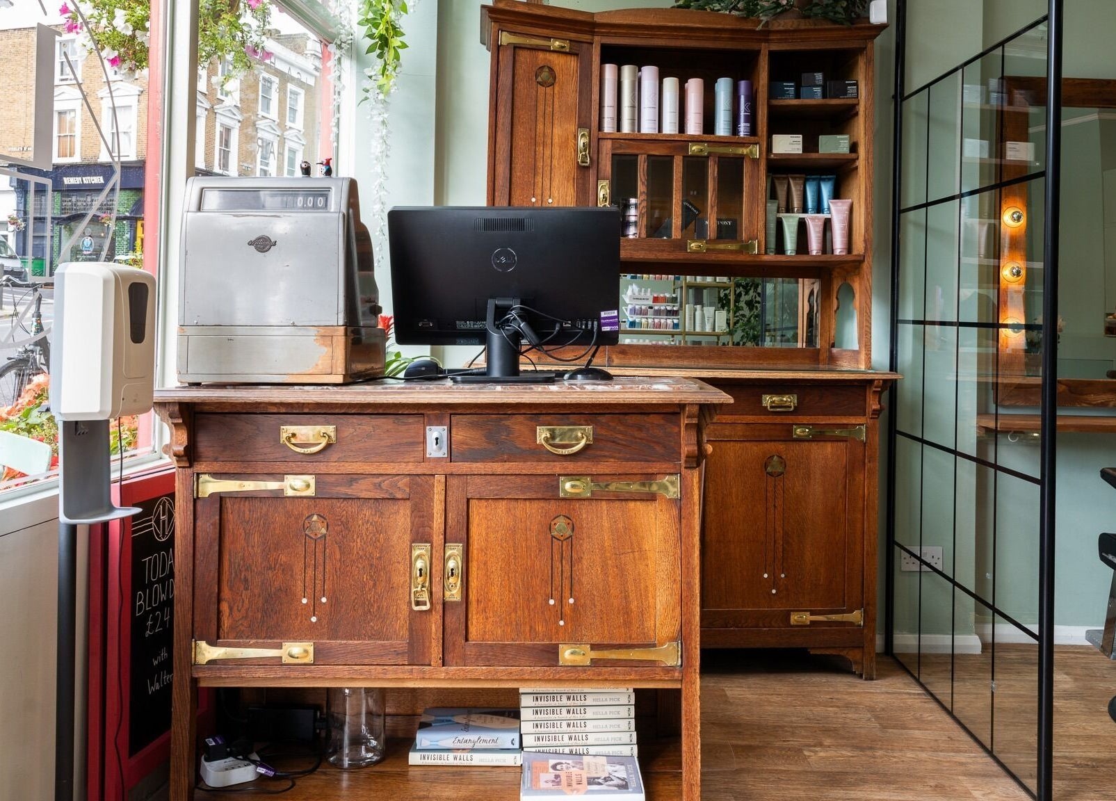 Elegant wooden salon workstation at Lisa Hauck, London, England, GB, featuring stylist tools and products.