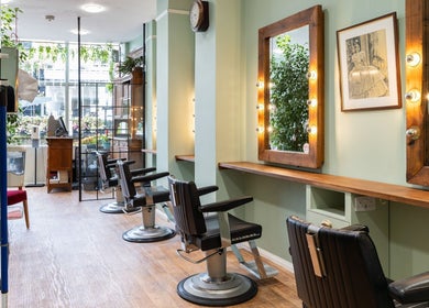 Stylish salon interior with salon chairs and mirrors at Lisa Hauck in London, England, GB.