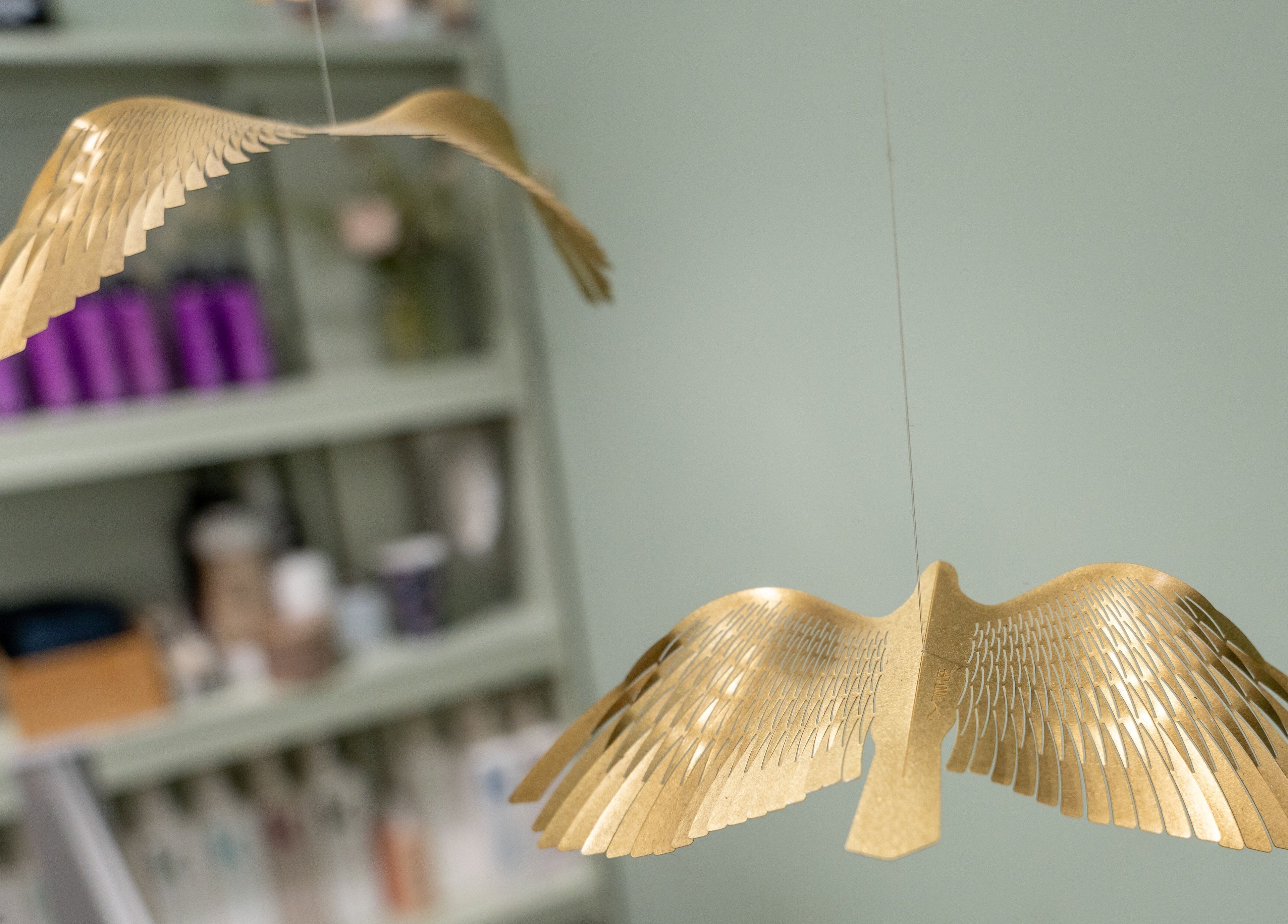 Elegantly crafted golden bird decor at Lisa Hauck, London, England, GB, enhancing the space's calming ambiance.