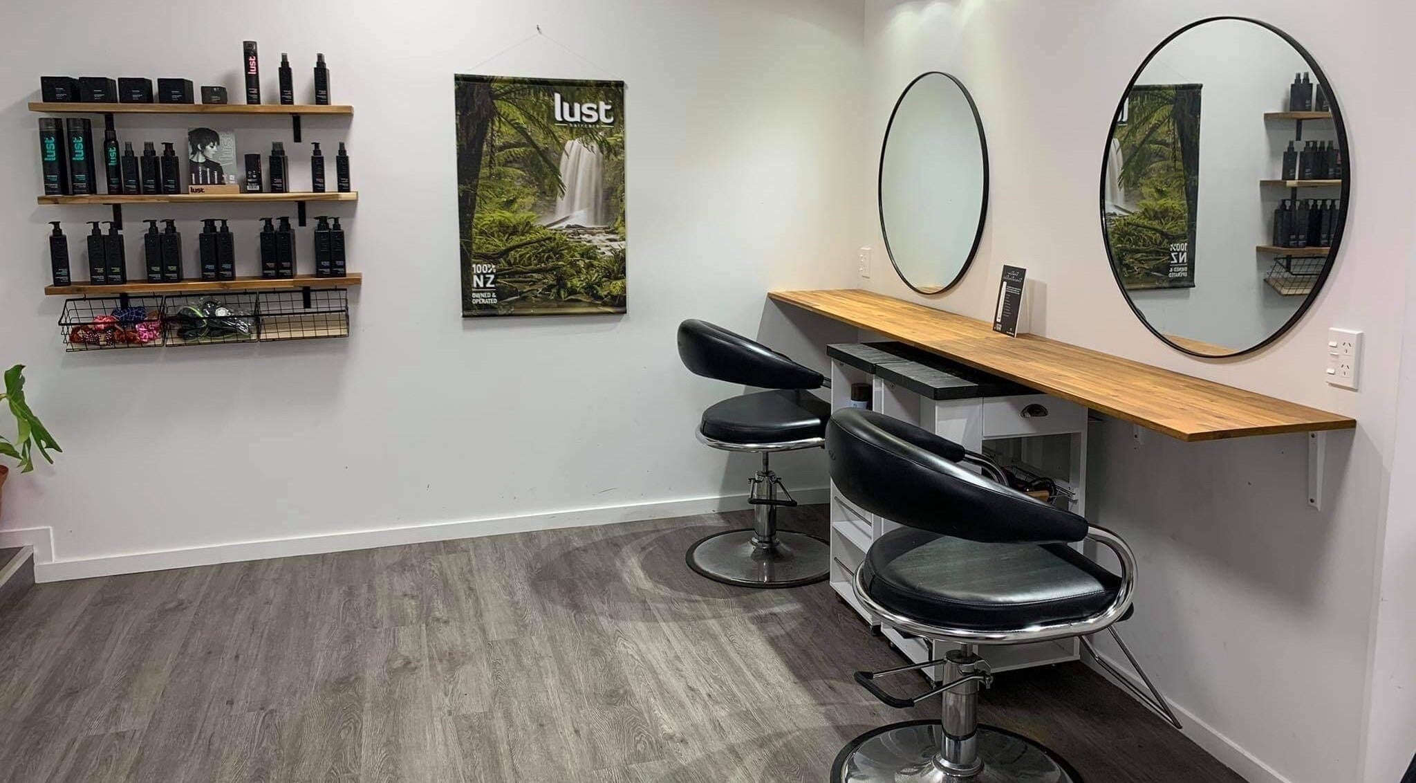 Elegant salon chairs and wall-mounted products at Self Care Status, Dairy Flat, Auckland, NZ.