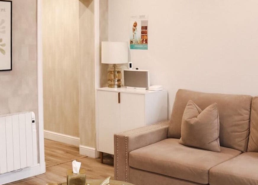 Inviting lounge area of Hannah McCoy Clinic Liverpool featuring a beige sofa and elegant decor. Liverpool, England, GB.