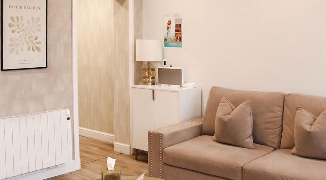 Inviting lounge area of Hannah McCoy Clinic Liverpool featuring a beige sofa and elegant decor. Liverpool, England, GB.