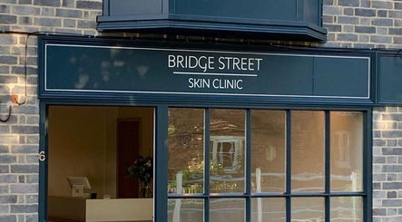 Front view of Bridge Street Skin Clinic in Hungerford, England, GB, showcasing its glass facade.
