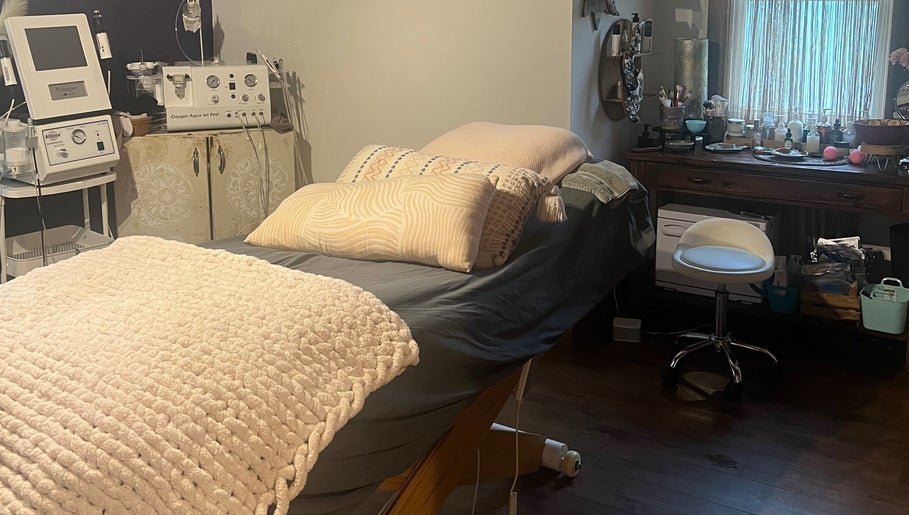 Relaxing treatment room at Mayra Elaine Beauty in Merrillville, Indiana, US, featuring a comfortable bed and equipment.