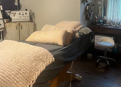 Relaxing treatment room at Mayra Elaine Beauty in Merrillville, Indiana, US, featuring a comfortable bed and equipment.
