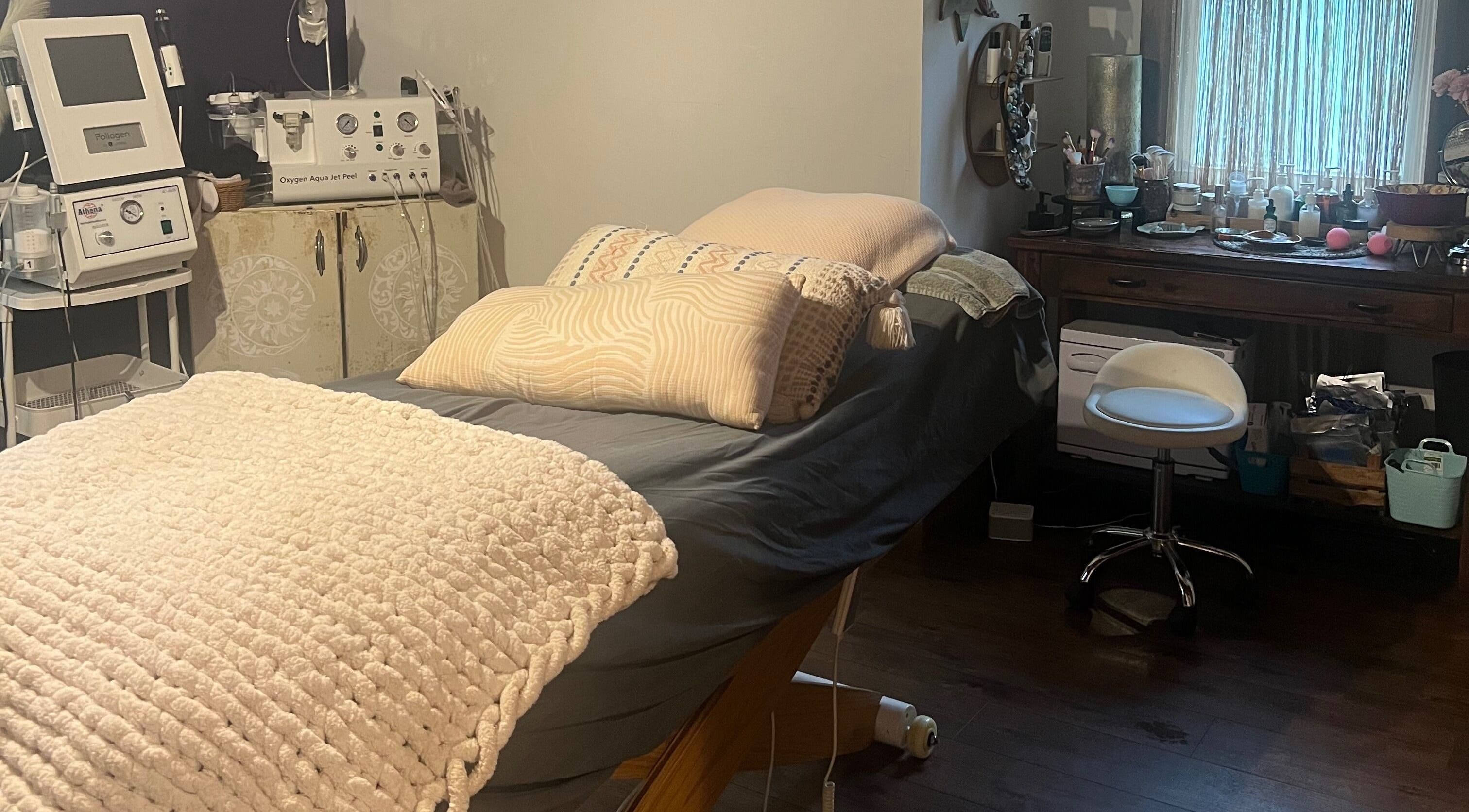 Relaxing treatment room at Mayra Elaine Beauty in Merrillville, Indiana, US, featuring a comfortable bed and equipment.