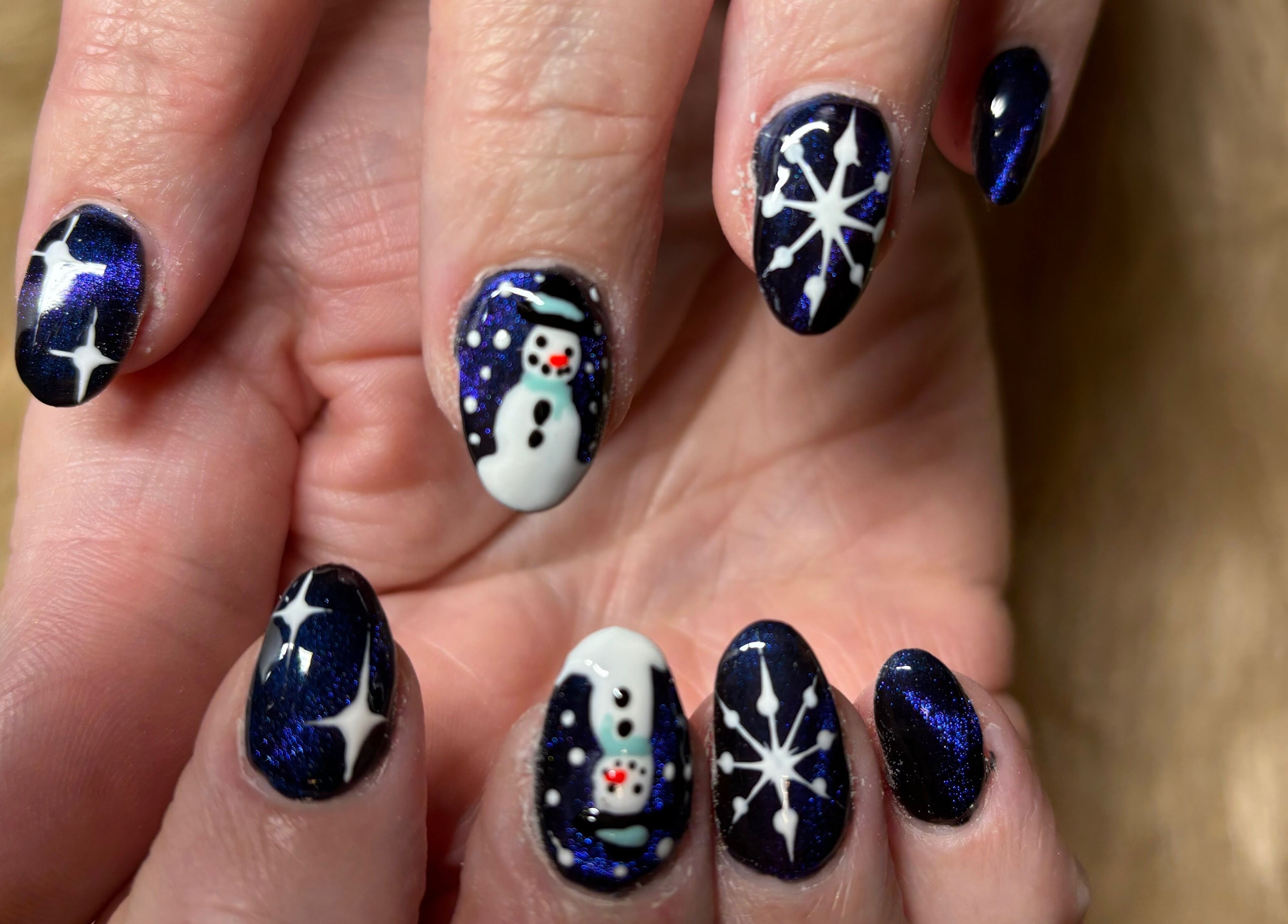 Snowman nail art design at Twinkle Toes and Fingers & Aesthetics, Taverham, England, GB.