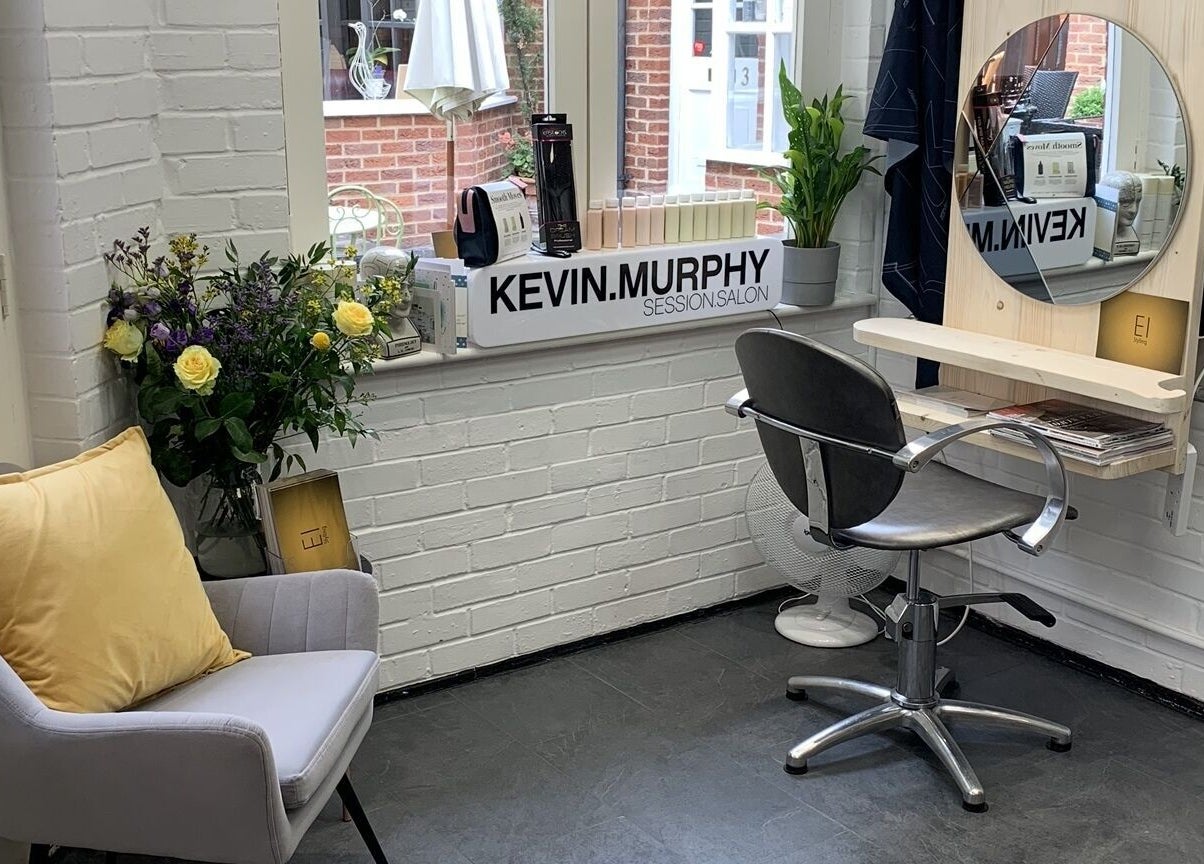 Eistyling salon corner with chair, mirror, and plants in Bedford, England, GB.