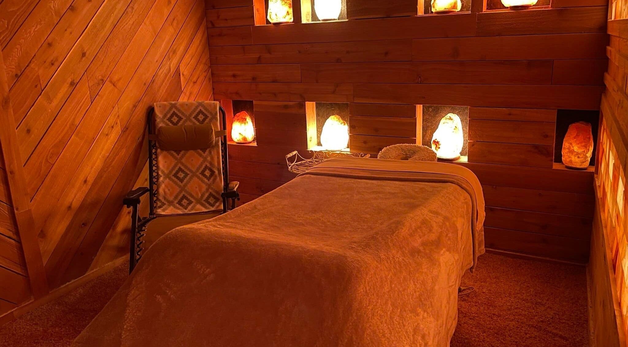 Cozy salt therapy room at Oasis Detox Spa for Women in Adairsville, Georgia, US, featuring warm wood decor.