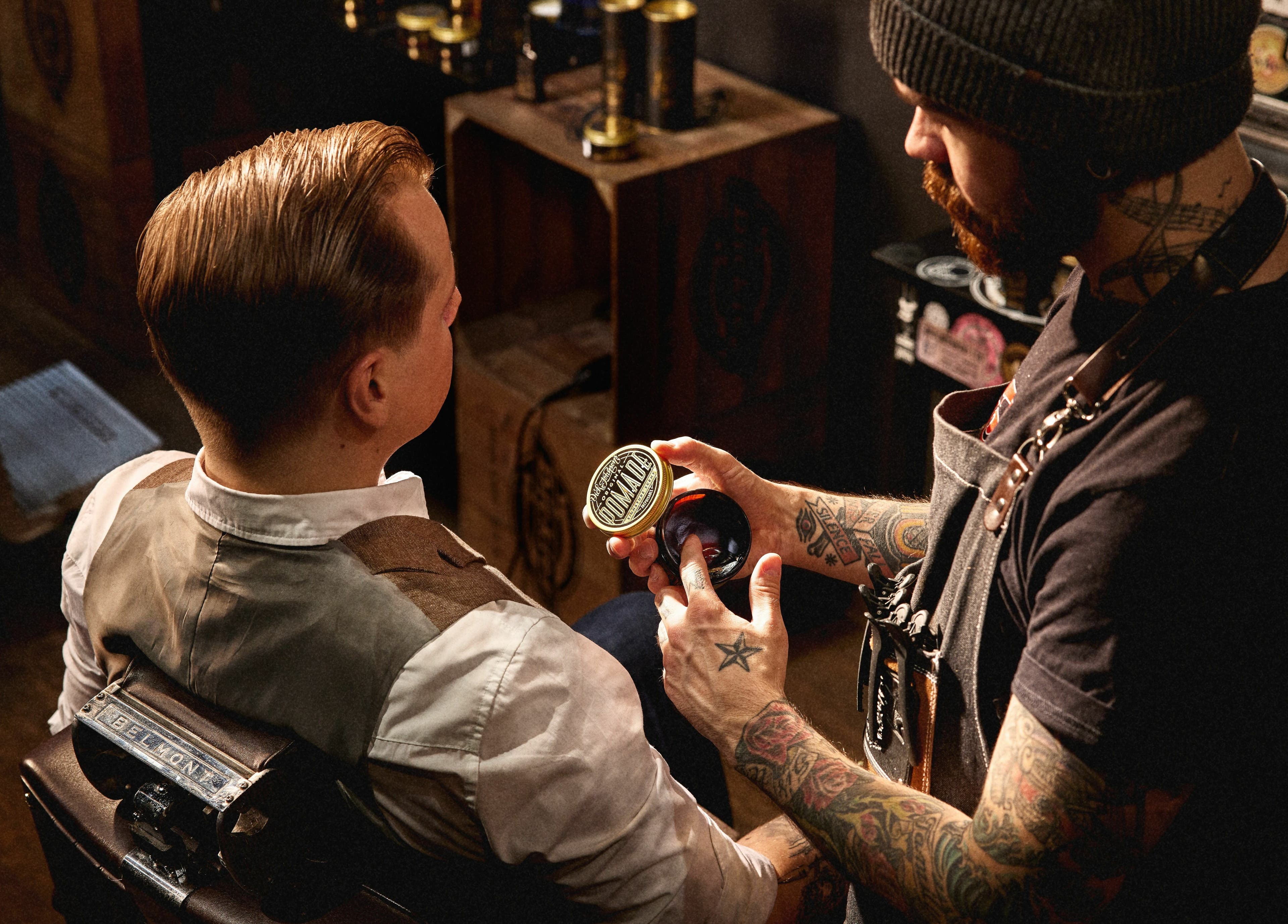 Barber at Dick Johnson | Turku styling a client's hair with pomade in Turku, FI.