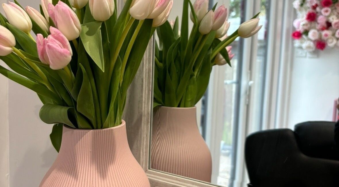 Elegant tulip vase at Lenice Kennedy Hair, Burton Latimer, England, GB, stylish salon decor.