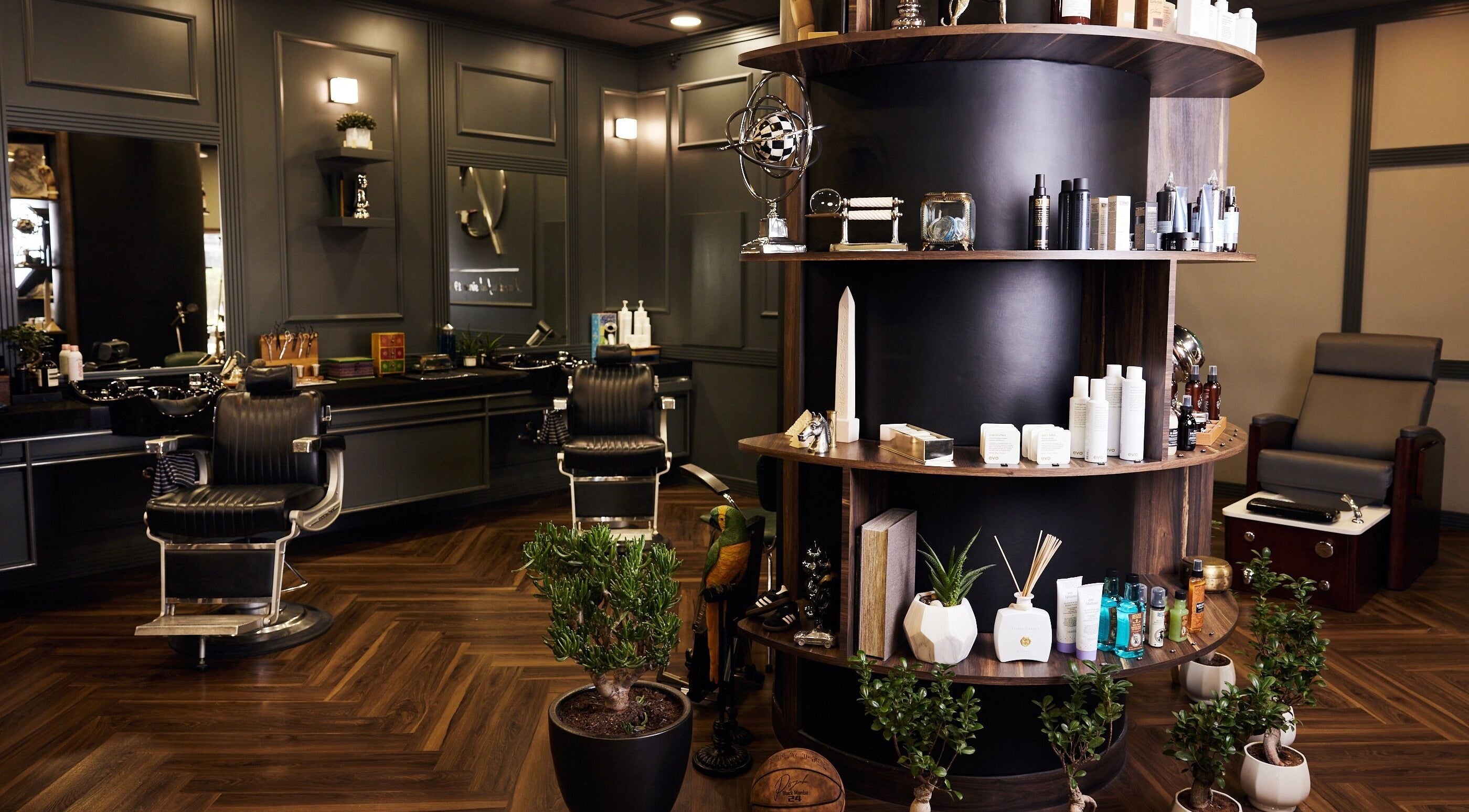 Luxurious interior of CG Barbershop in Dubai, AE showcasing plush barber chairs and premium grooming products.