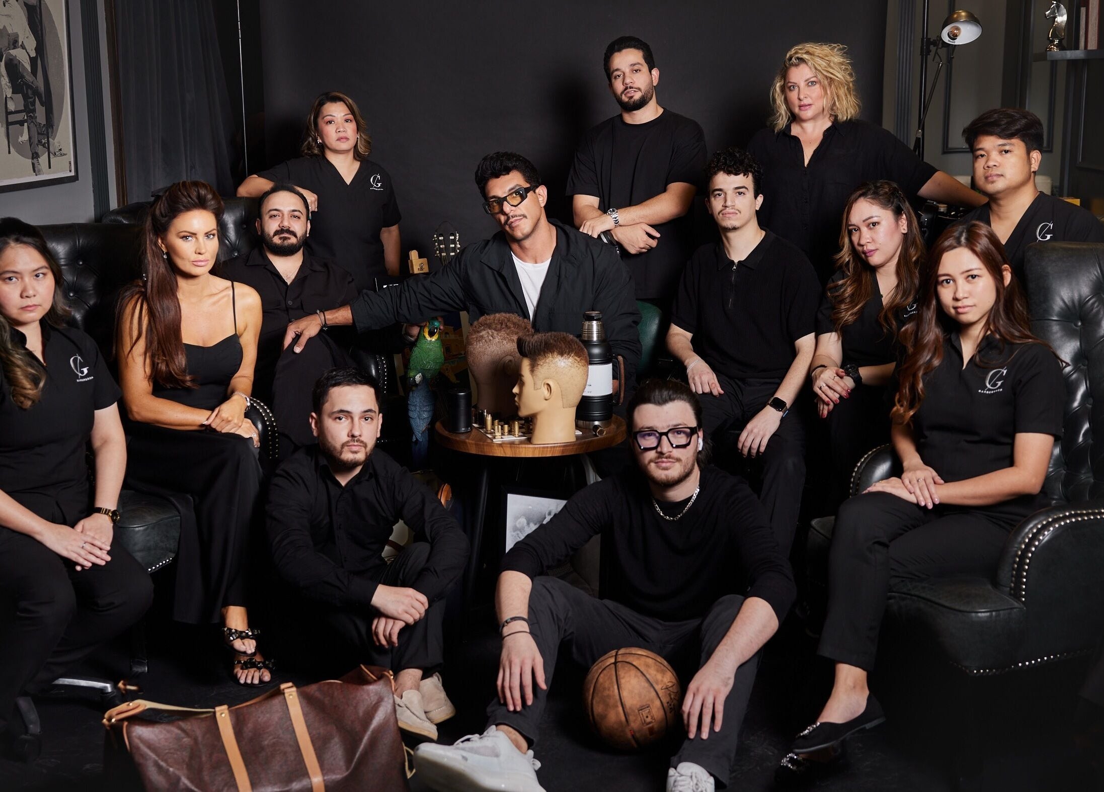 The CG Barbershop team in Dubai, AE, showcases professional unity and expertise in their chic salon setting.