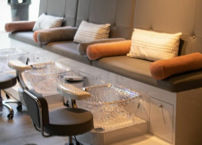 Luxurious pedicure stations at BeeQ Downtown A2, Ann Arbor, Michigan, US with plush seating and crystal basins.