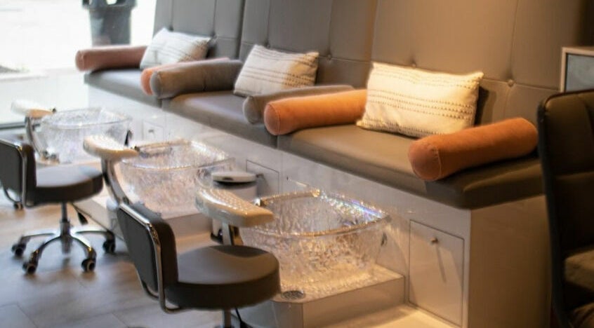 Luxurious pedicure stations at BeeQ Downtown A2, Ann Arbor, Michigan, US with plush seating and crystal basins.