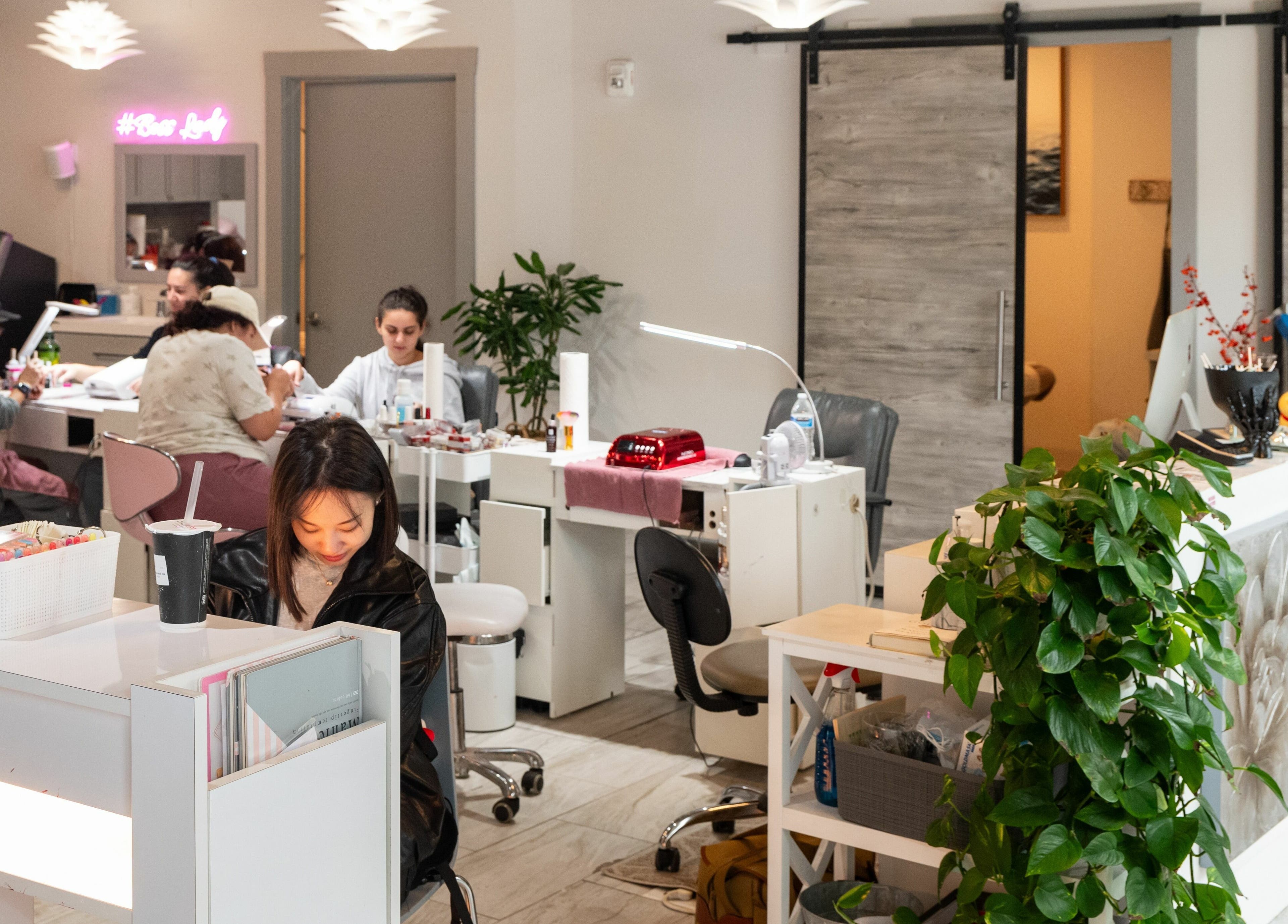 Relaxing ambiance at BeeQ Downtown A2, Ann Arbor, Michigan, US with clients enjoying beauty treatments.