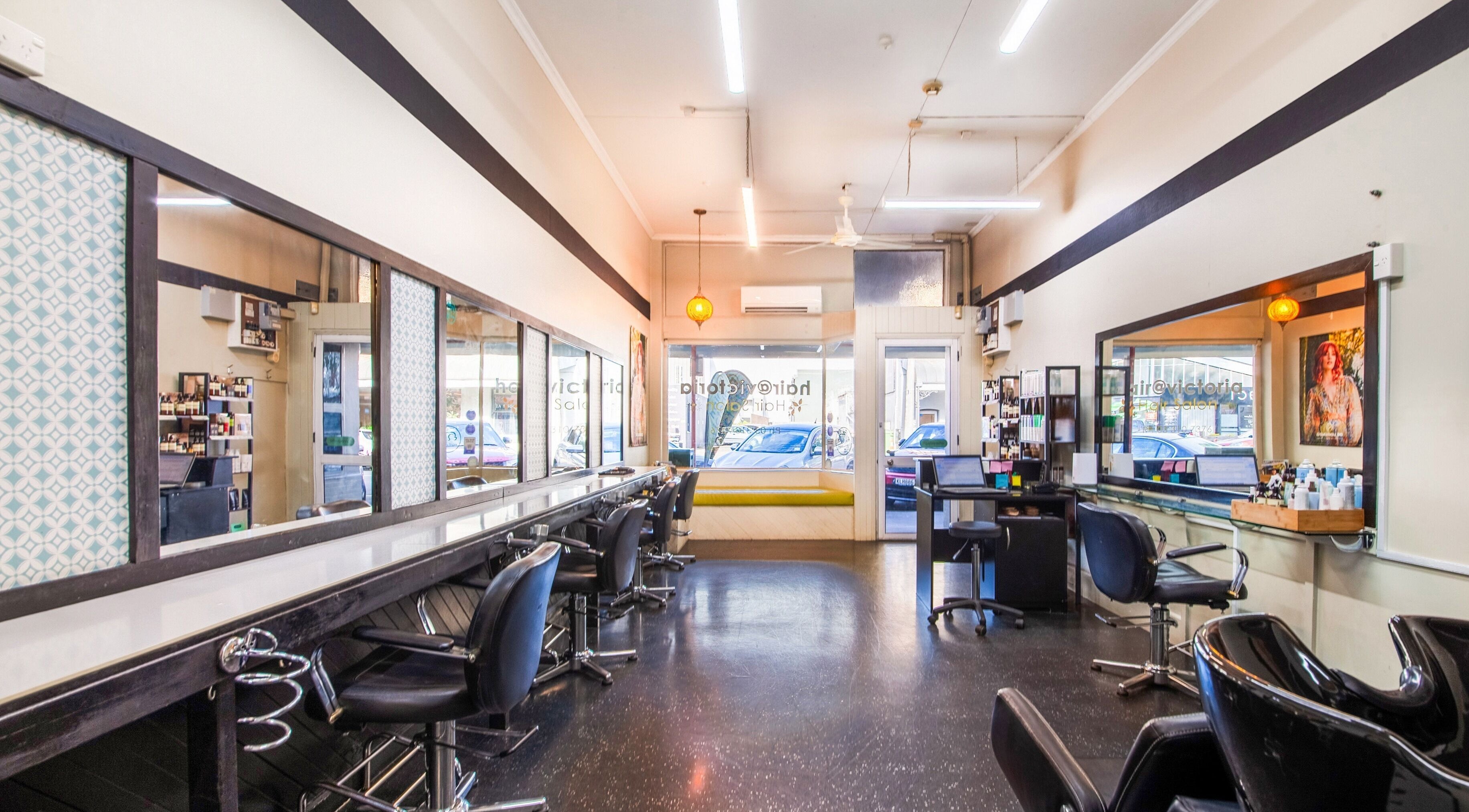 Interior of Hair At Victoria salon in Rangiora, Canterbury, NZ, showcasing modern styling stations and mirrors.
