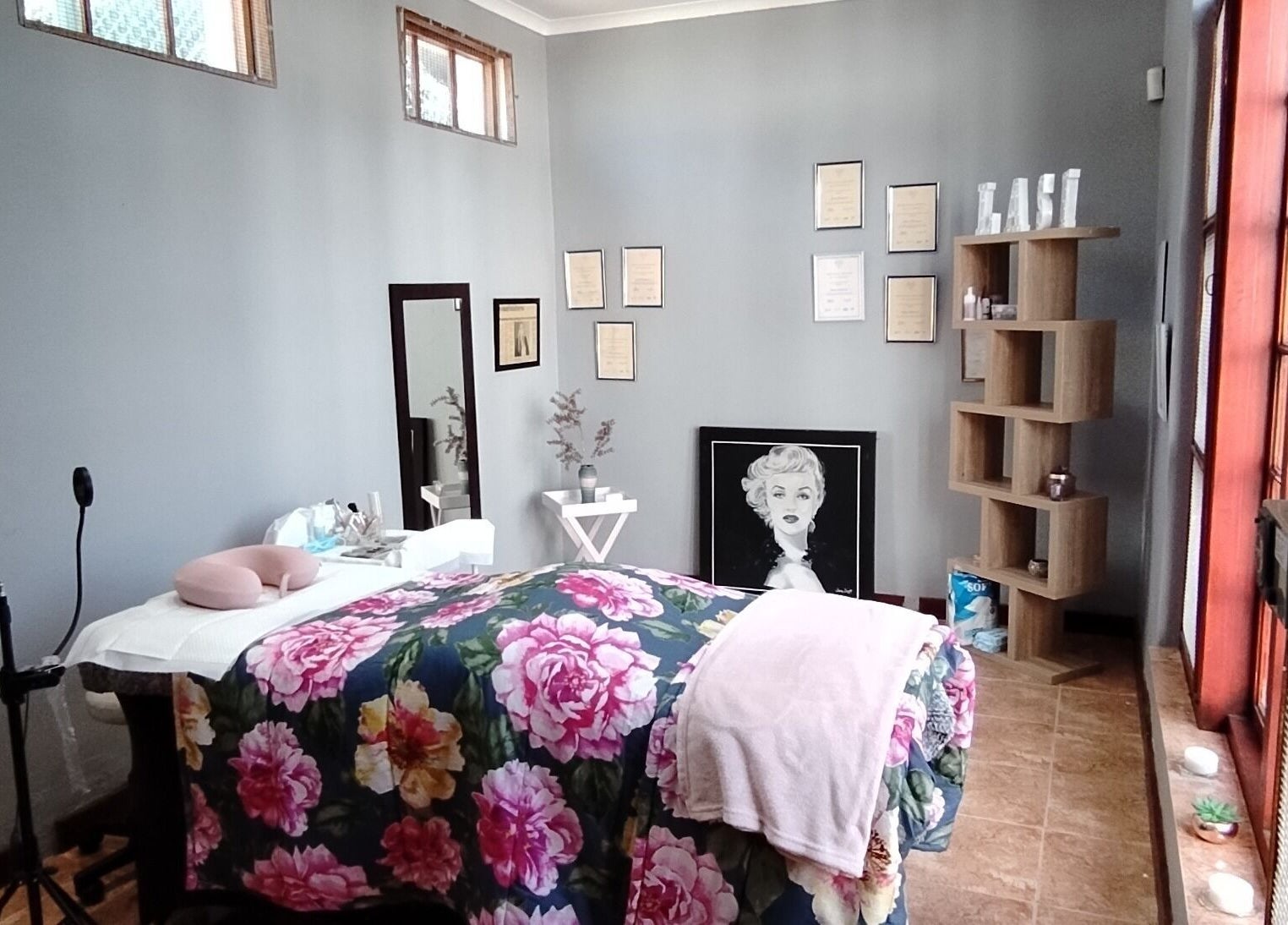 Relaxing treatment room at The Brow Room, Port Elizabeth, Eastern Cape, ZA with floral decor and calming ambiance.