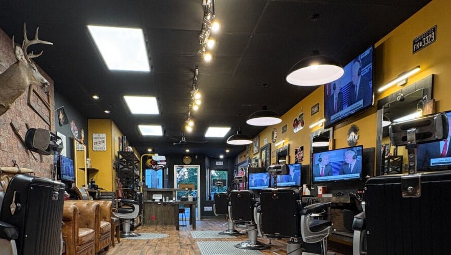 Inside Kings and Little Ones Barber Shop in Cornwall, Ontario, CA with sleek chairs and vintage decor.