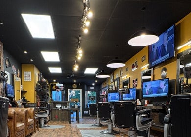 Inside Kings and Little Ones Barber Shop in Cornwall, Ontario, CA with sleek chairs and vintage decor.