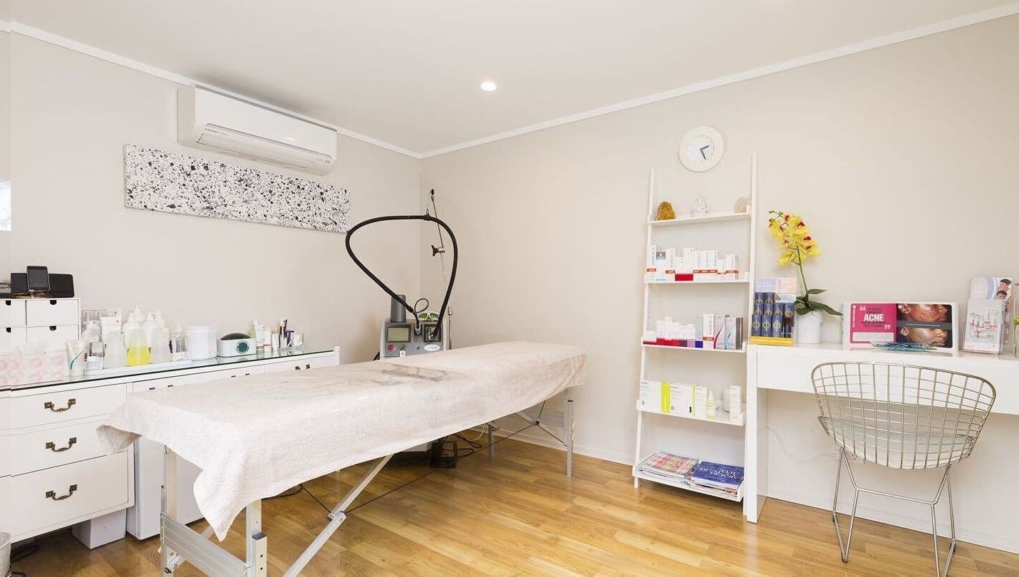 Relaxing treatment room at Beautilase, Auckland, Auckland, NZ, with spa bed and skincare products.
