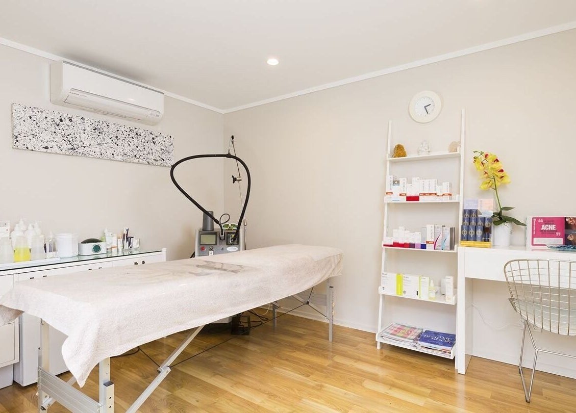 Relaxing treatment room at Beautilase, Auckland, Auckland, NZ, with spa bed and skincare products.