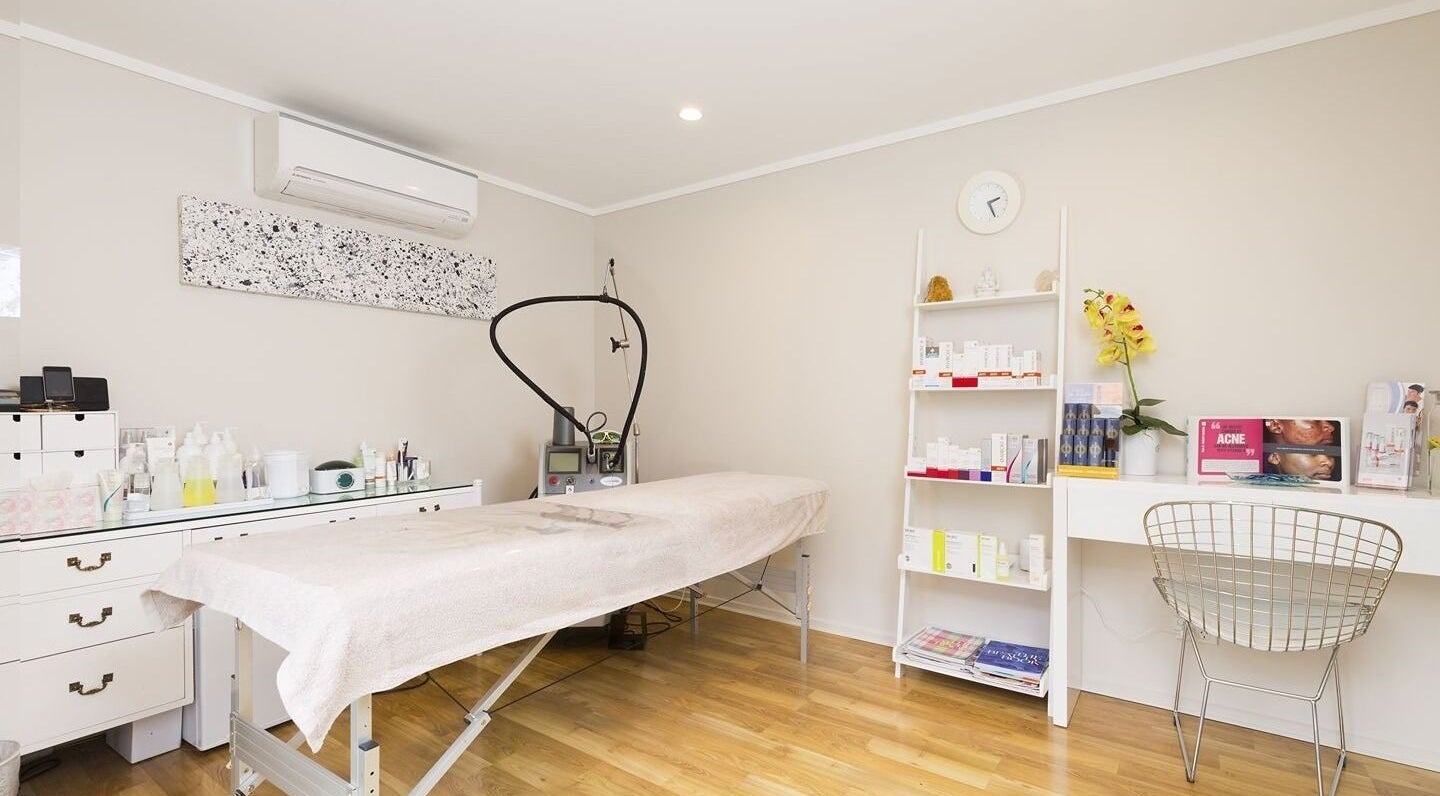 Relaxing treatment room at Beautilase, Auckland, Auckland, NZ, with spa bed and skincare products.