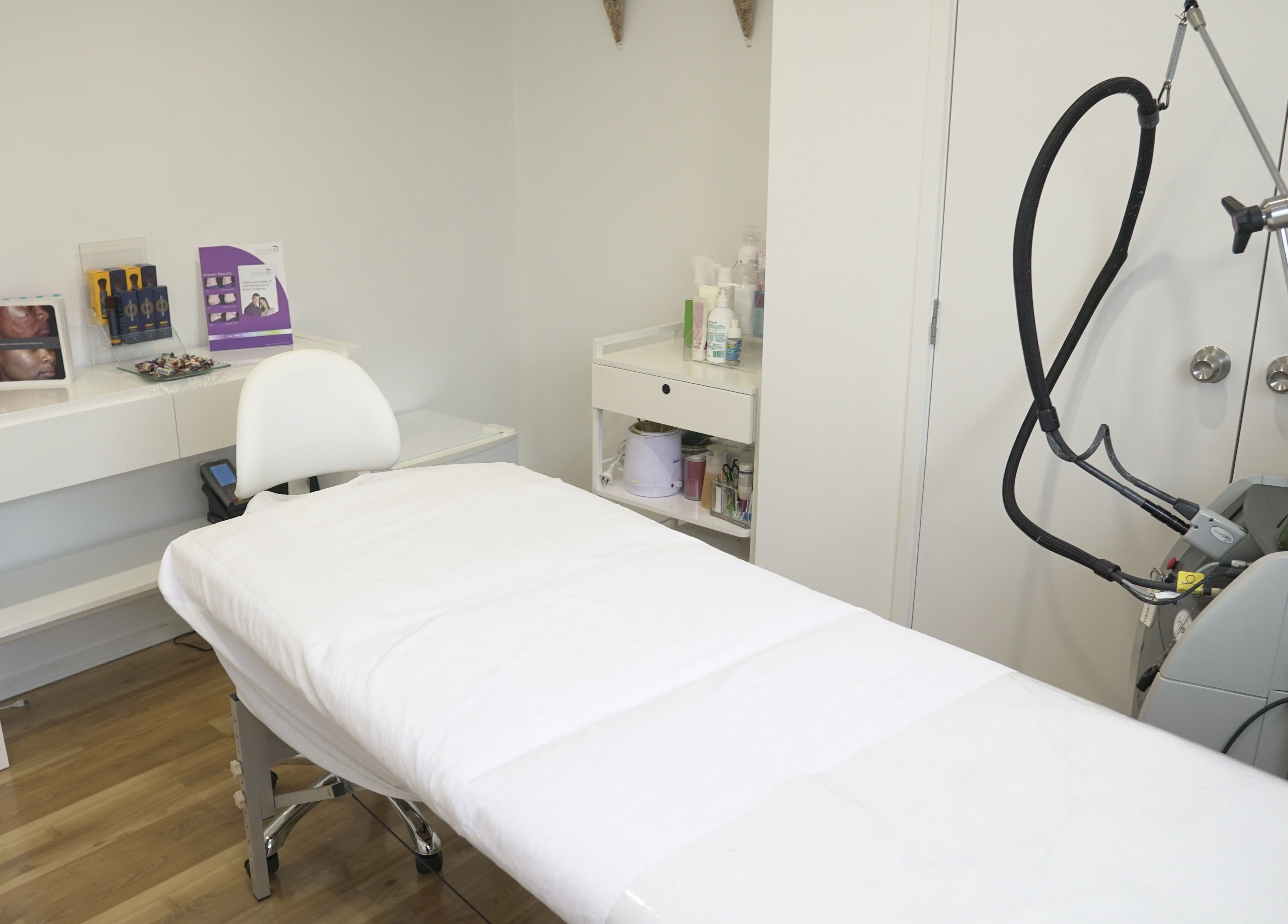 Relaxing spa room at Beautilase, Auckland, NZ, featuring a treatment bed and equipment.