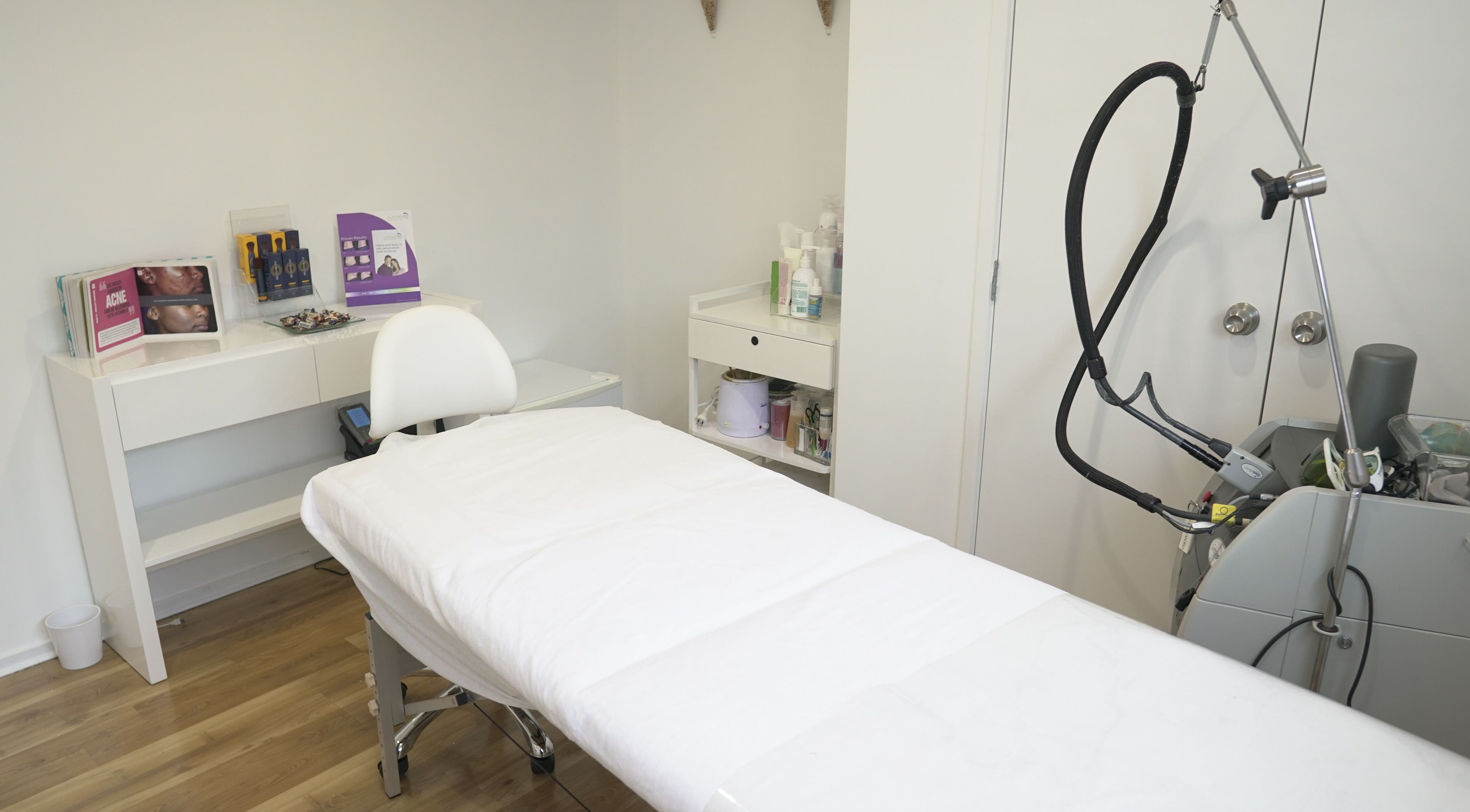 Relaxing spa room at Beautilase, Auckland, NZ, featuring a treatment bed and equipment.