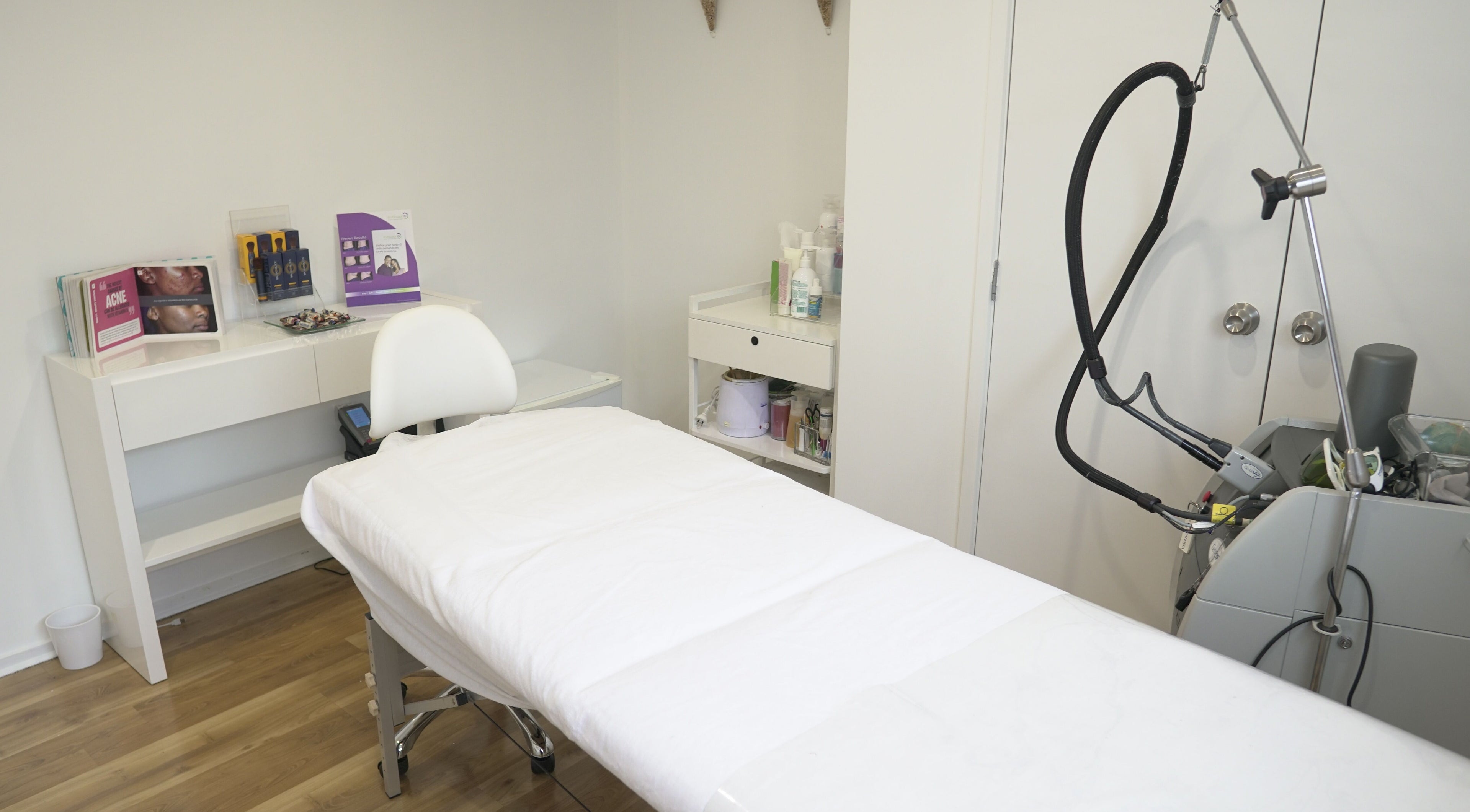 Relaxing spa room at Beautilase, Auckland, NZ, featuring a treatment bed and equipment.