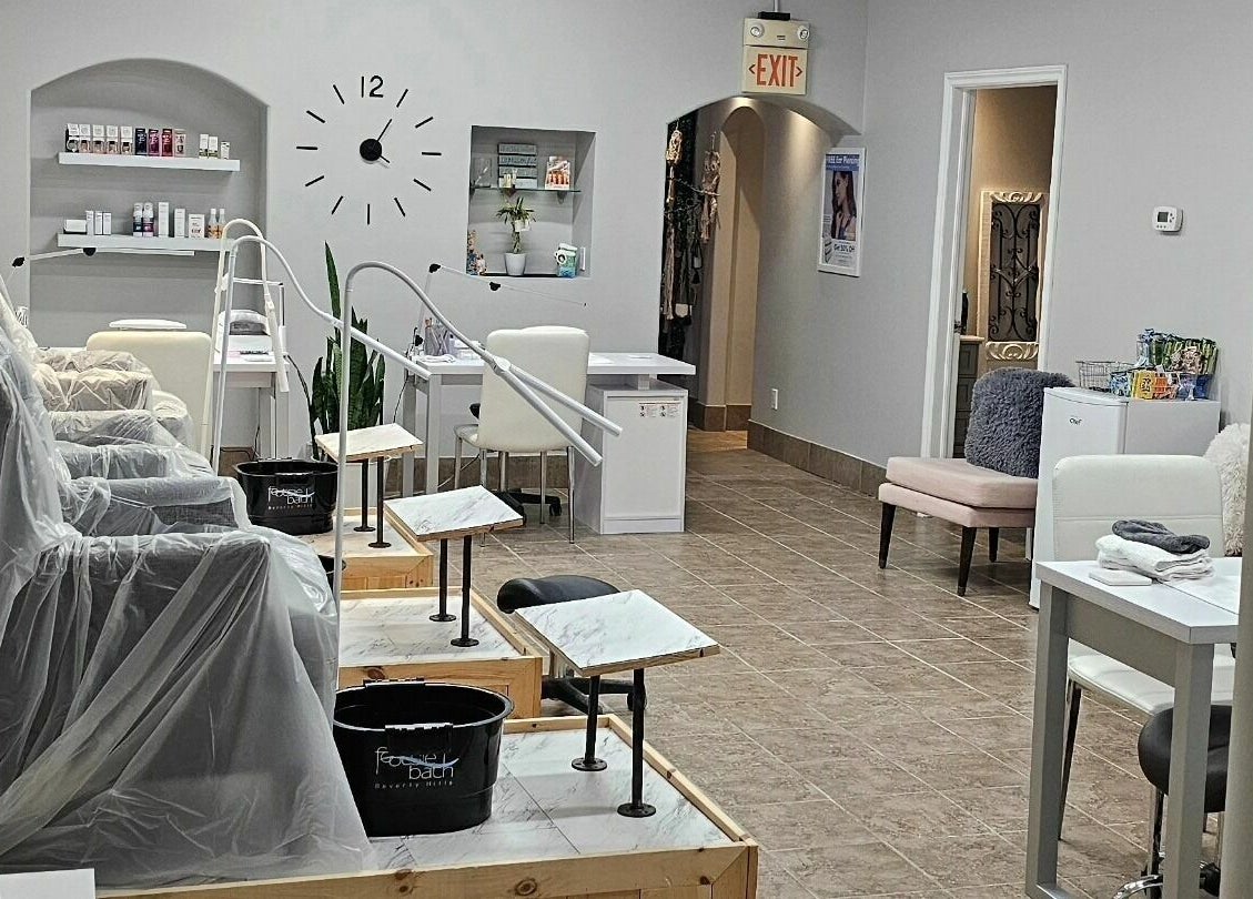 Chic interior of Hometown Laser Clinic and Spa in Tecumseh, Ontario, CA, featuring manicure stations and plush seating.