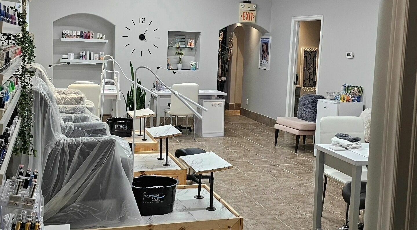 Chic interior of Hometown Laser Clinic and Spa in Tecumseh, Ontario, CA, featuring manicure stations and plush seating.
