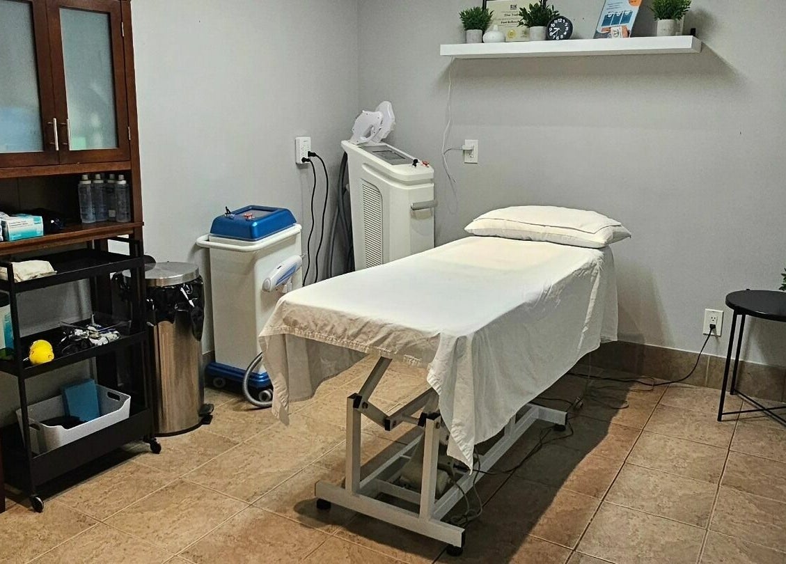 Treatment room at Hometown Laser Clinic and Spa in Tecumseh, Ontario, CA, featuring a comfortable treatment bed.