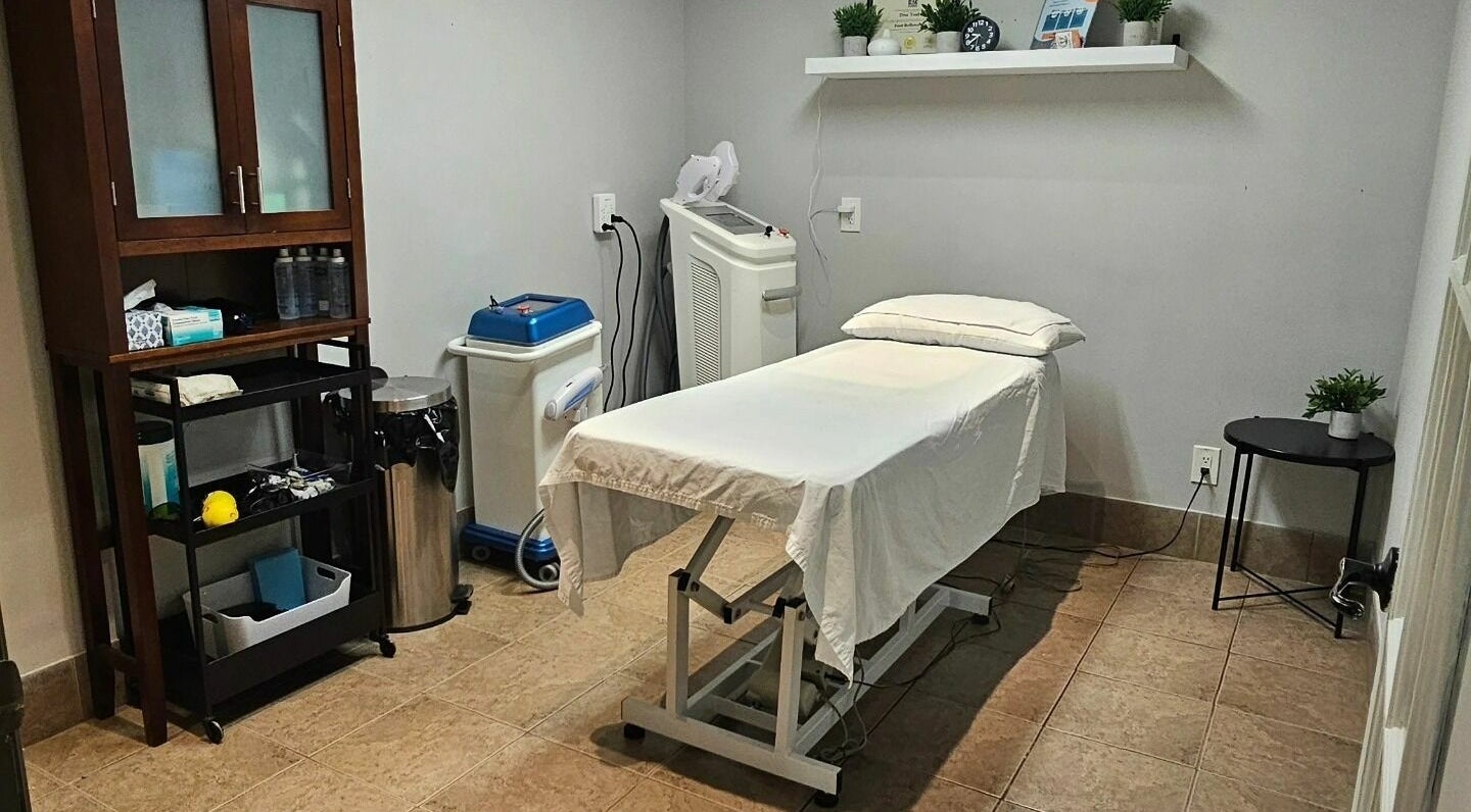 Treatment room at Hometown Laser Clinic and Spa in Tecumseh, Ontario, CA, featuring a comfortable treatment bed.