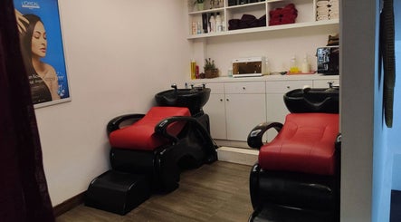 Cozy hair washing area at Shang Nyai Salon & Spa, Daerah Khusus Ibukota Jakarta, with red chairs and shelves.