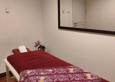Cozy massage room at Shang Nyai Salon & Spa, Daerah Khusus Ibukota Jakarta, featuring a red massage table.