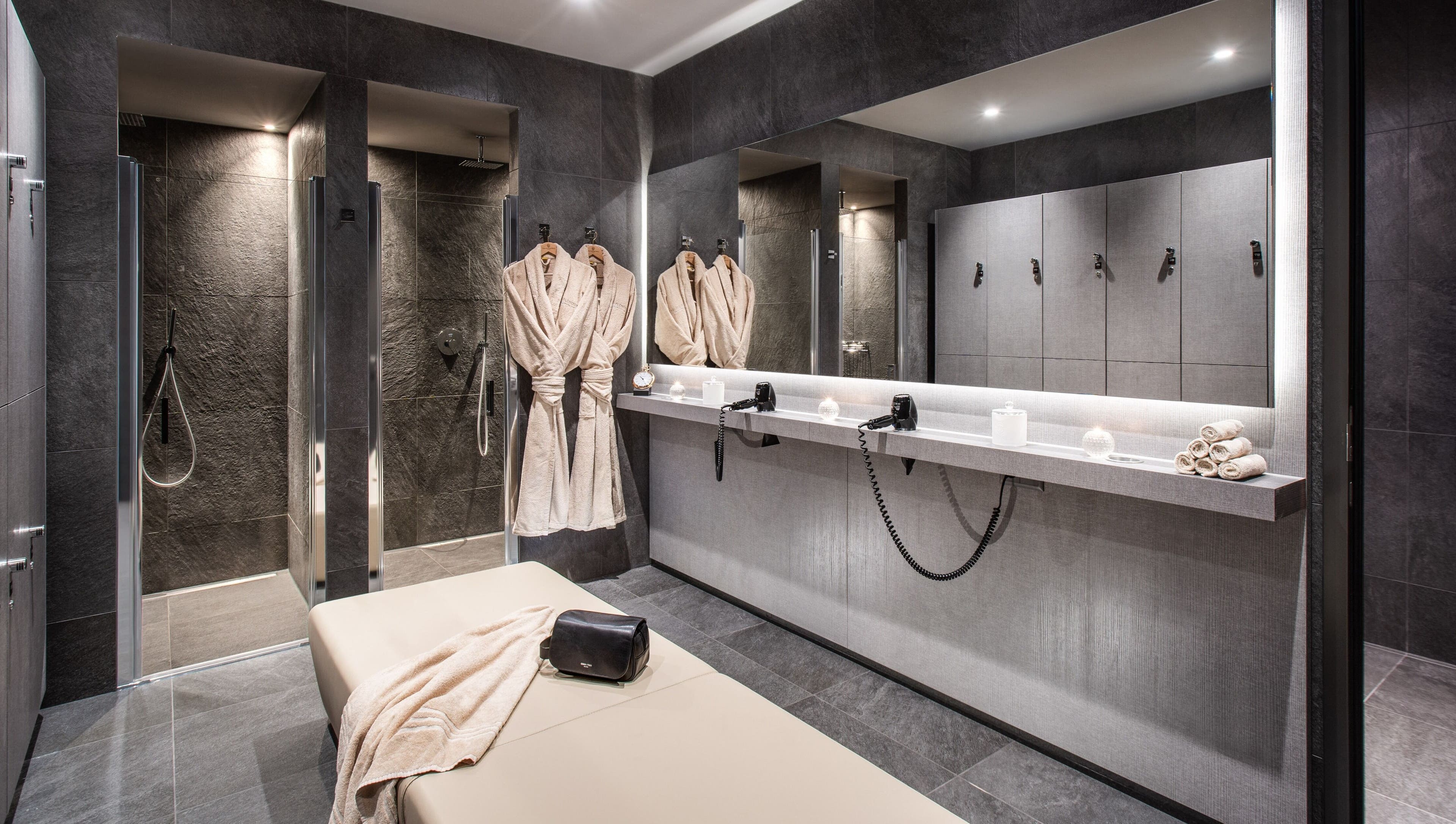 Elegant spa room at Hotel Splendide Royal, Lugano, Ticino, CH with robes, showers, and massage table.
