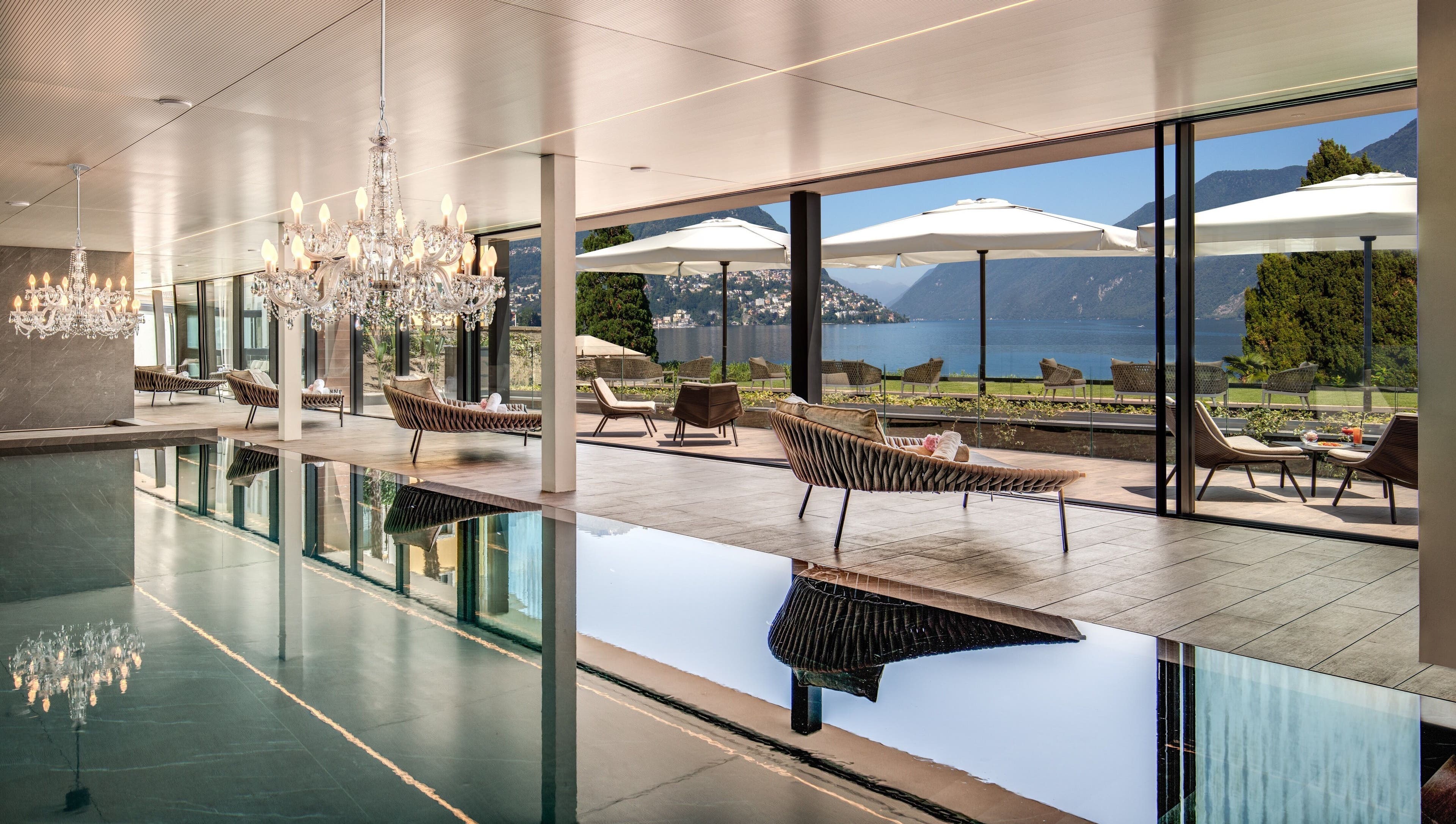 Luxurious pool area with chandeliers at Hotel Splendide Royal, Lugano, Ticino, CH offering lake views.